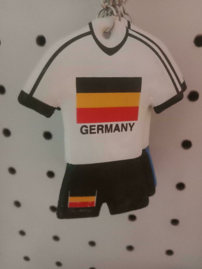Keychain shaped like a Germany soccer jersey with an upside-down flag, showcasing a perfectly preventable fail.