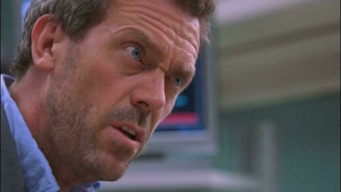 Close-up of a man with blue eyes showing a confused expression, representing bad movie details discussion in an online group.