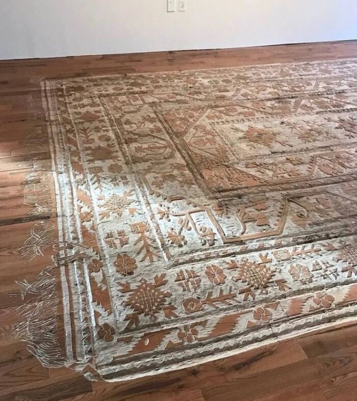 Warped and curled rug on wooden floor, an example of a DIY disaster that belongs in a museum of mistakes.