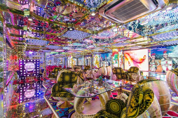 Vibrant and highly creative bar interior with colorful patterns, reflective surfaces, and eclectic furniture design.