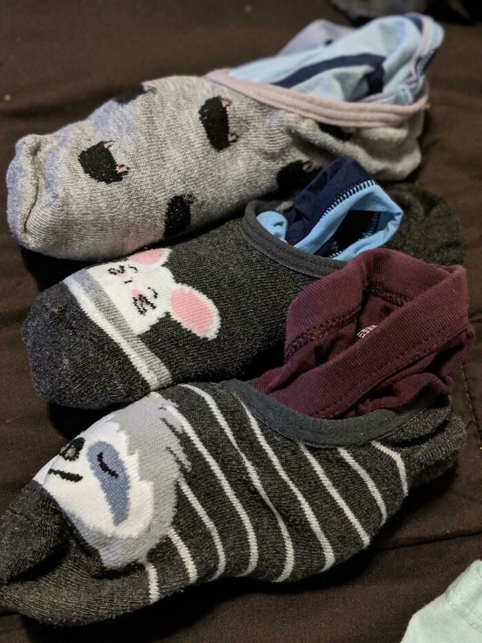 Three pairs of colorful animal-themed socks neatly paired using a genius life hack to keep them organized and matched.