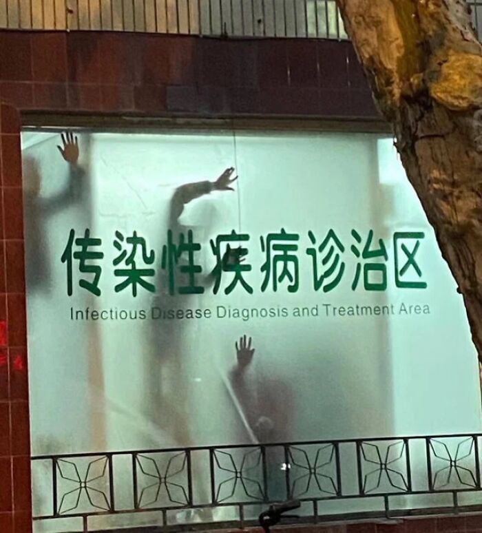 Silhouettes of hands pressed against a fogged glass window at an infectious disease diagnosis and treatment area, creepy moment.