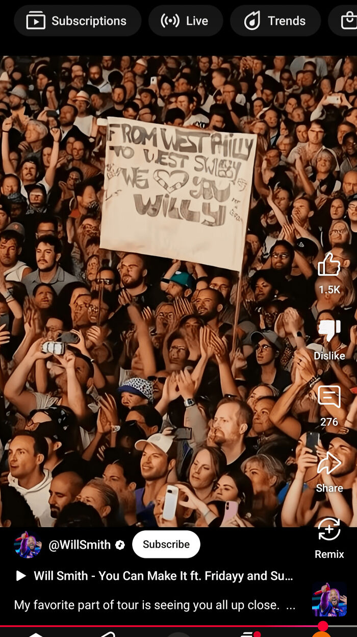 Crowd holding a handmade sign at a concert, capturing moments of there was an attempt with universe having different plans.