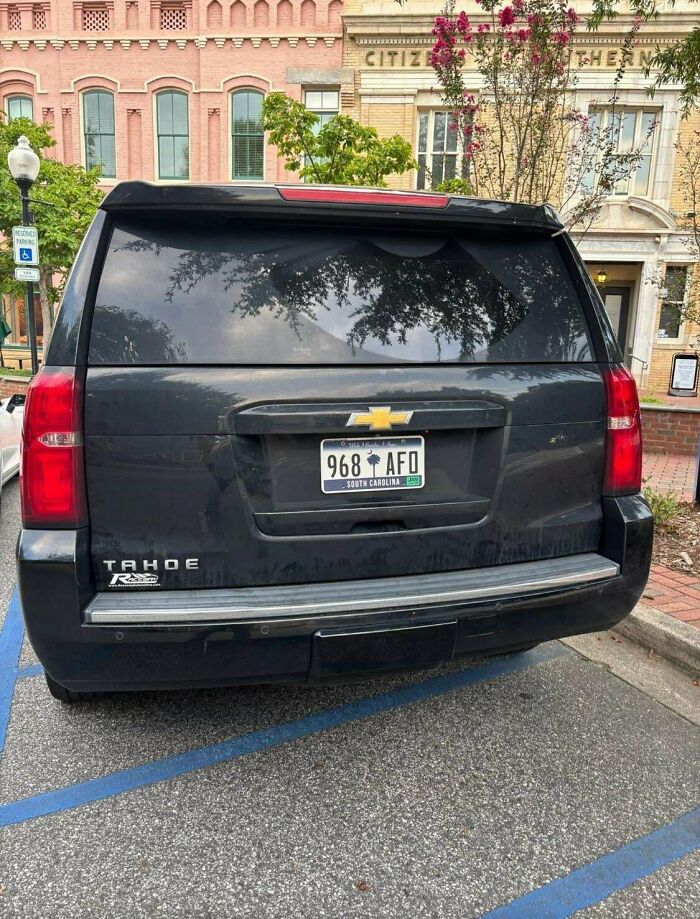 Black Chevrolet Tahoe parked incorrectly, with universe having completely different plans for the vehicle’s placement.