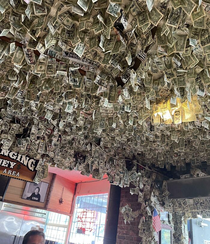 Bar ceiling covered with dollar bills in a creative restaurant featured among bars and restaurants around the world.