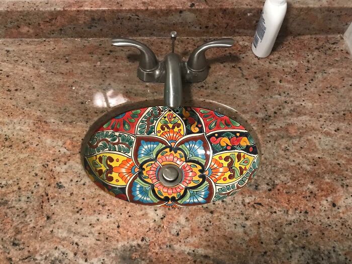 Colorful decorative sink basin with floral patterns in a bar or restaurant showcasing creativity and design excellence.