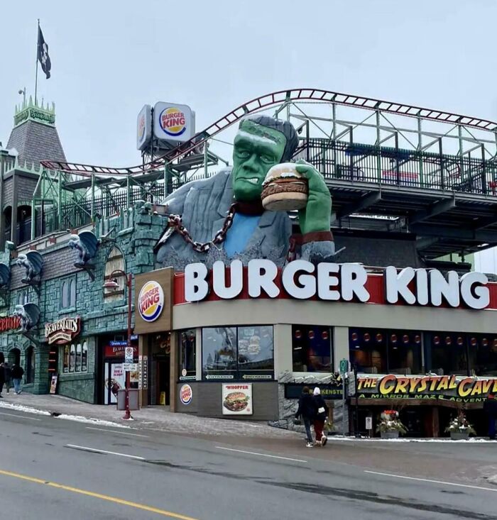 Creative Burger King with Frankenstein figure holding a burger, showcasing unique bars and restaurants worldwide.