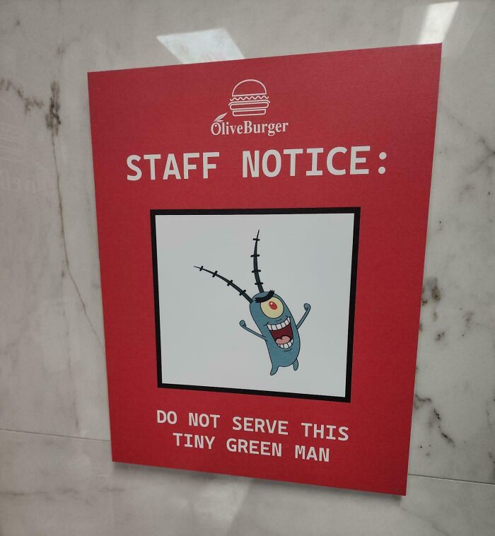 Red staff notice sign at a bar with a cartoon character warning, highlighting creativity in bars and restaurants worldwide.