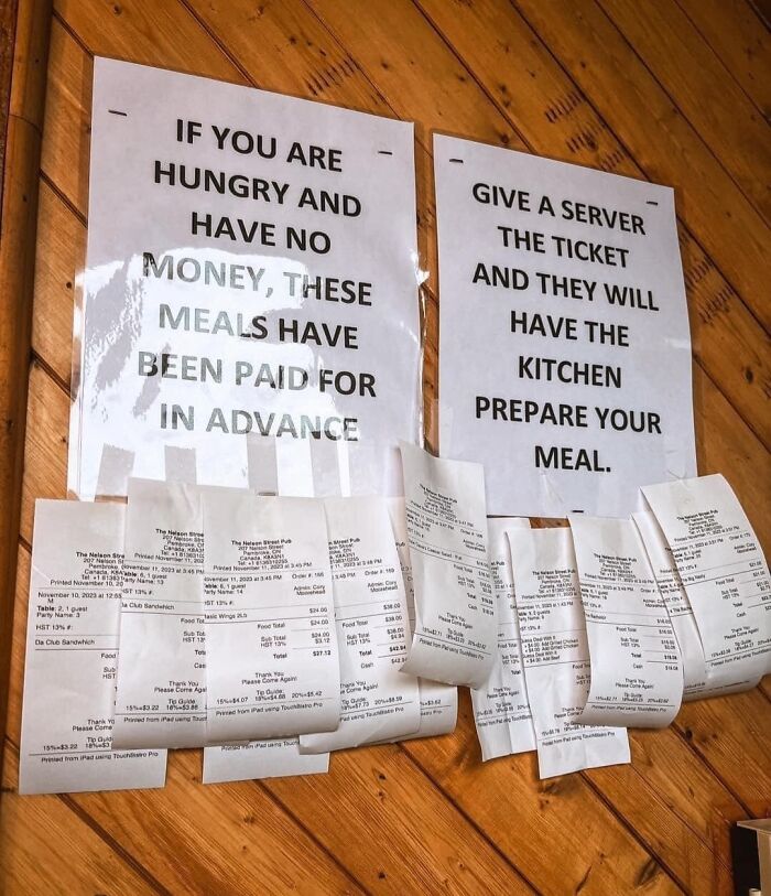 Signs and receipts at a creative bar offering prepaid meals for hungry customers with no money in an innovative restaurant.