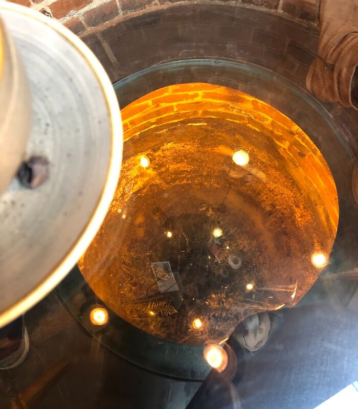 Unique creative bar table with glowing circular light and reflective surface in a stylish restaurant setting