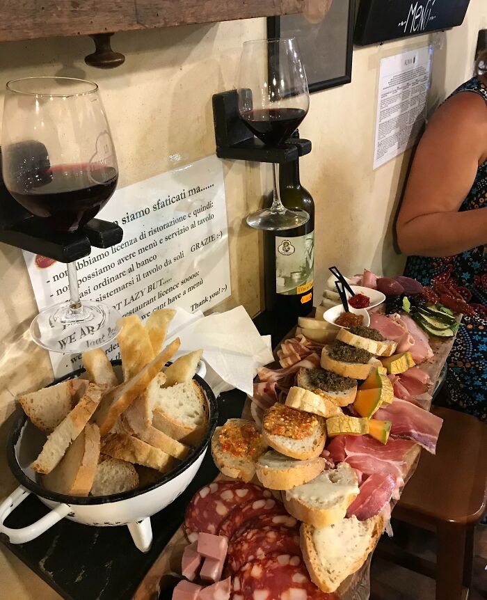 Creative bar serving charcuterie and wine in unique glass holders, showcasing innovative presentation at a top-rated restaurant.