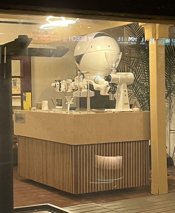 Creative bar setup featuring a futuristic robotic coffee maker at a unique bars and restaurants location.