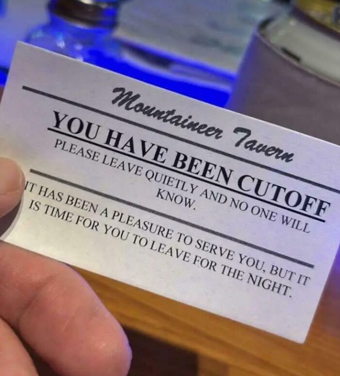 Hand holding a creative cutoff card from a bar, highlighting unique bars and restaurants known for creativity.