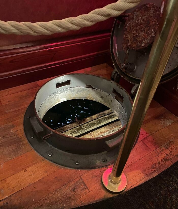 Unique creative bar design featuring a floor hatch with water below in an innovative bar and restaurant setting.