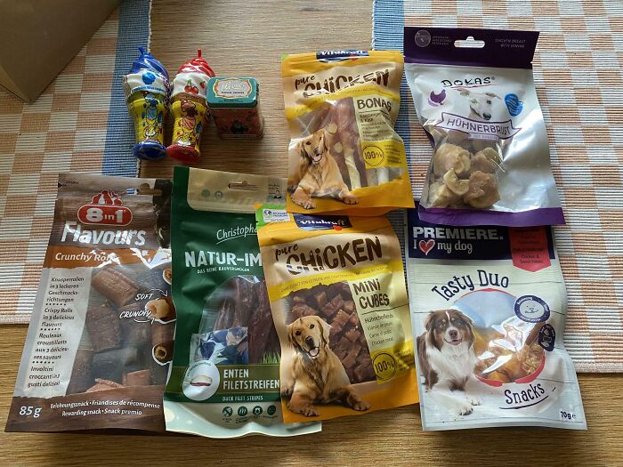 Assorted dog treats and snacks displayed on a table, reflecting wholesome-kind-neighbors sharing pet care.
