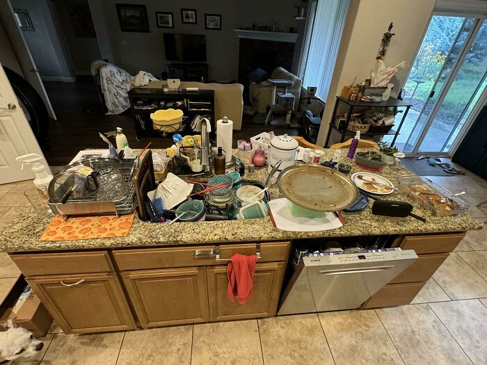 Cluttered kitchen counter with dirty dishes and utensils scattered, illustrating selfish people losing all common decency.
