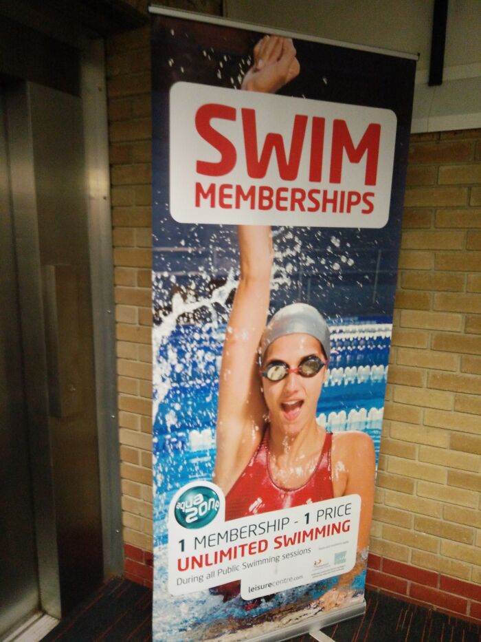 Swimmer with distorted arm and hand in Photoshop fail on a swim membership promotional banner at a leisure center.