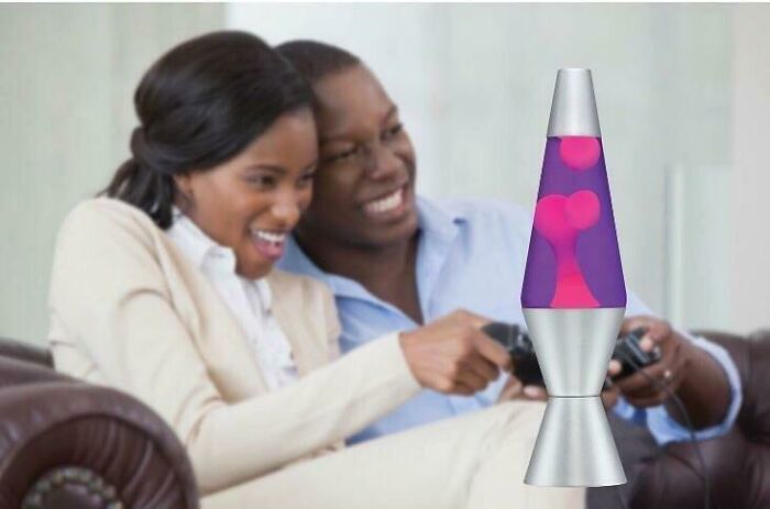Couple playing video games on a couch with a poorly edited lava lamp, showcasing Photoshop fails.