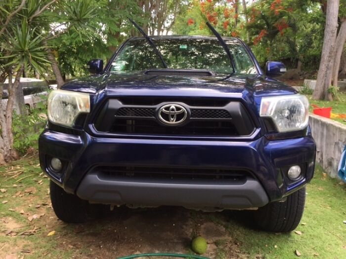 Front view of a blue Toyota truck with raised windshield wipers, demonstrating a genius life hack people actually use outdoors.