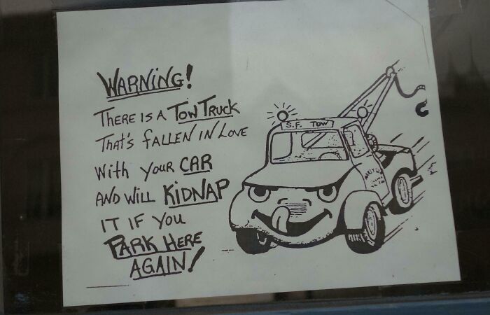 Hand-drawn humorous sign warning about a tow truck kidnapping cars, showcasing hilariously random notes and messages.