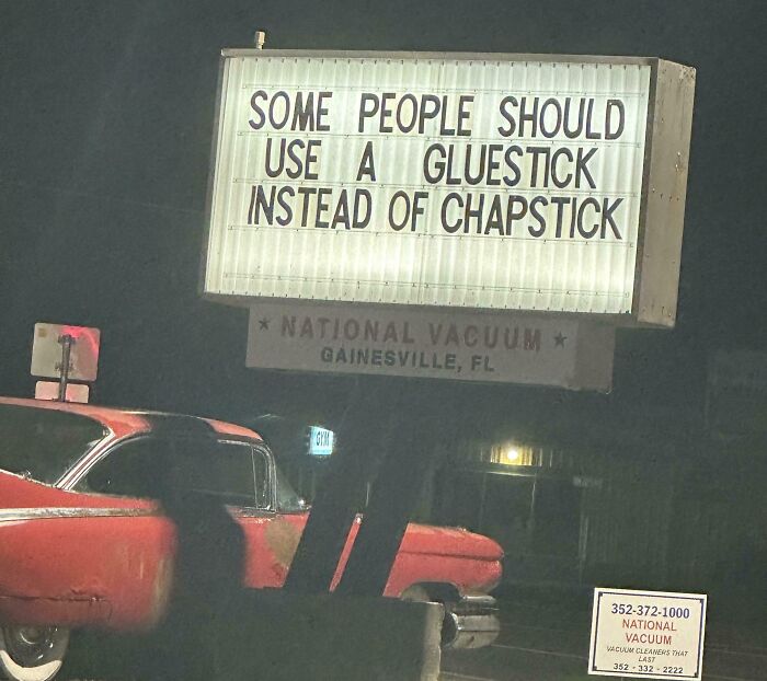 Humorous roadside sign at night with random funny message reminding not to take life too seriously.