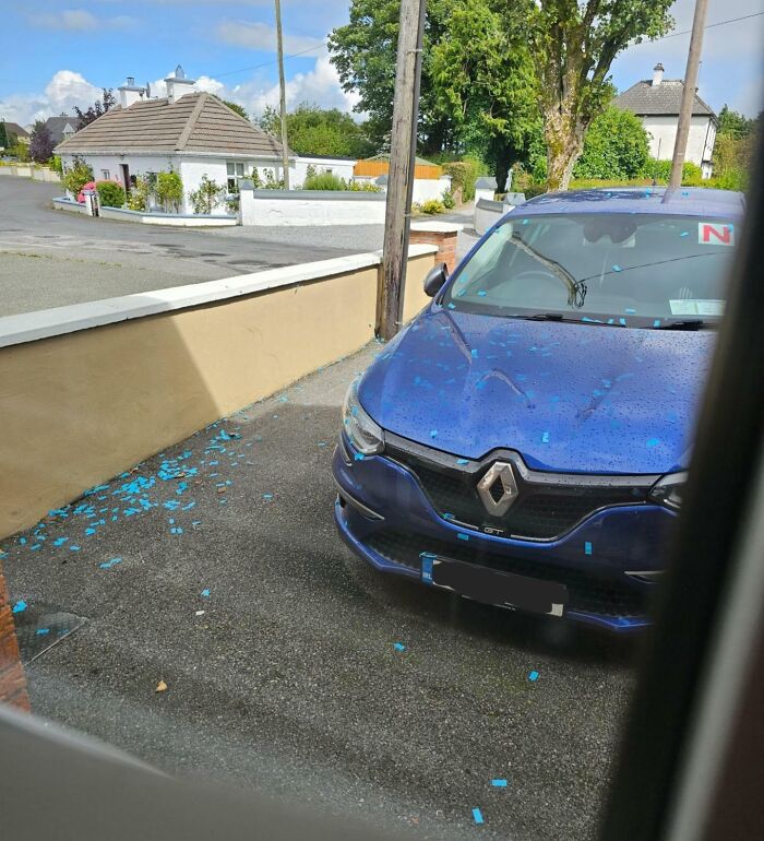 Blue car covered in blue confetti pieces parked on driveway, showing selfish people making life harder for everyone else.