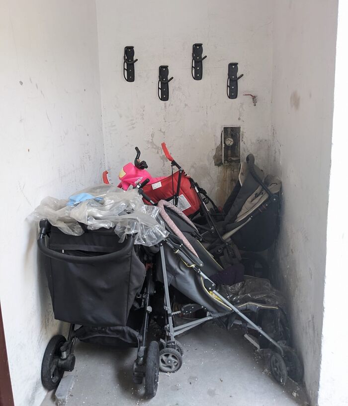 Cluttered corner with multiple abandoned strollers showing selfish people lost decency making life harder for others.