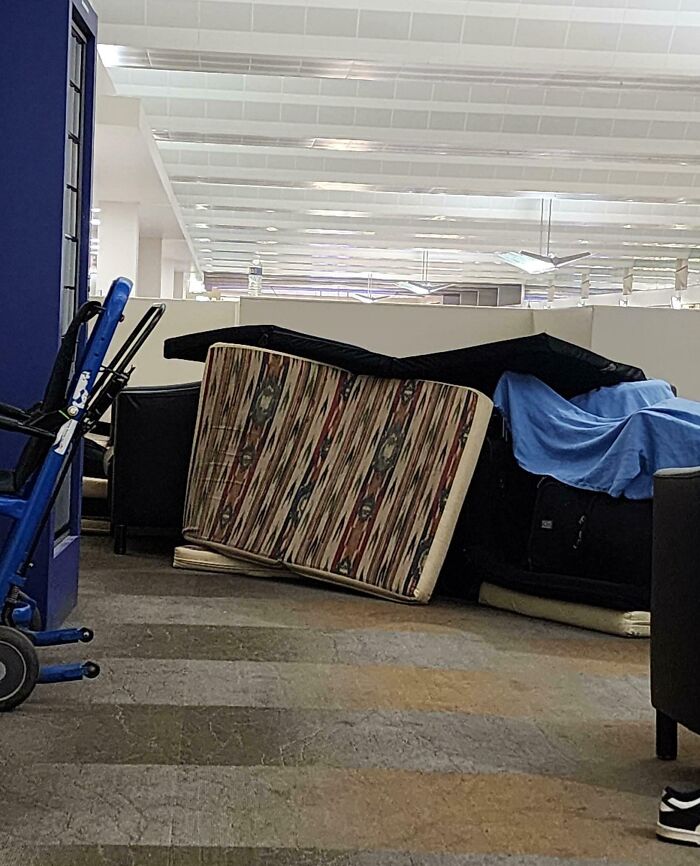 Cluttered indoor area with piled sofas and mattresses, illustrating selfish people causing inconvenience and lack of common decency.