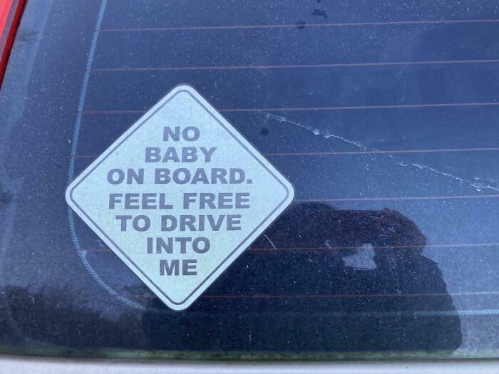 Sticker on a car window with a funny sign that humorously invites others to drive into the vehicle, showcasing random notes.