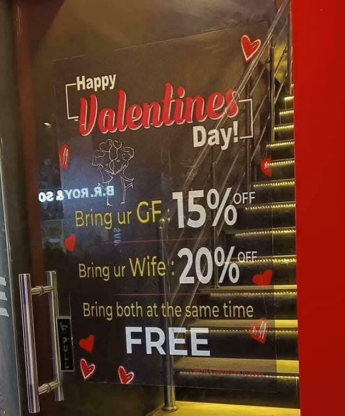Valentines Day sign offering discounts for bringing girlfriend, wife, or both with humorous notes and messages to not take life seriously.