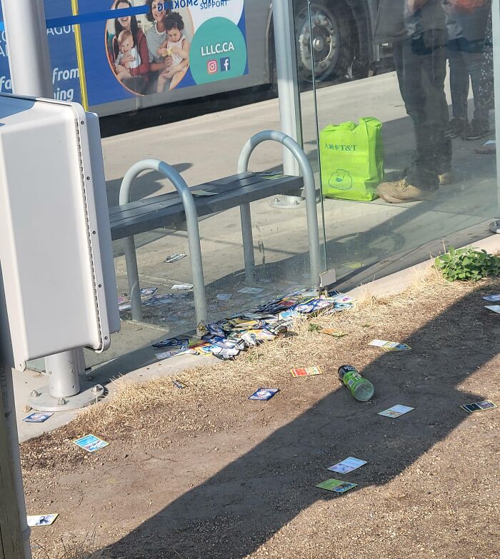 Litter strewn at a bus stop showing selfish people lost all common decency and made life harder for everyone else.