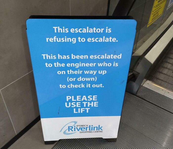 Funny escalator sign with a random note about refusing to escalate, using humor to remind not to take life seriously.