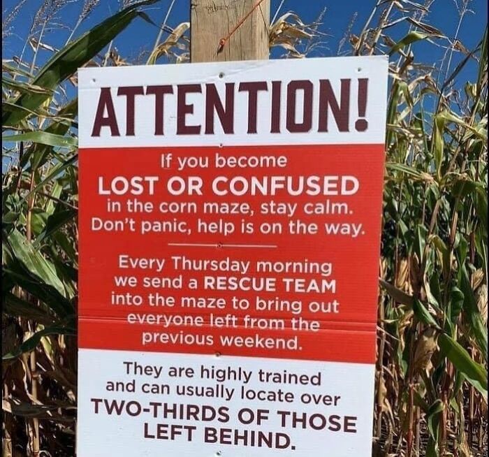 Funny and random corn maze rescue sign humorously reminding visitors not to take life too seriously.