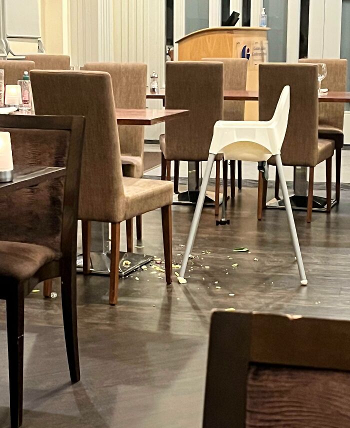 Messy restaurant floor with scattered food around a high chair, showing selfish people lost common decency in public spaces.