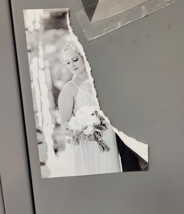 Torn photo of a woman in a white dress holding flowers, illustrating selfish people losing common decency.