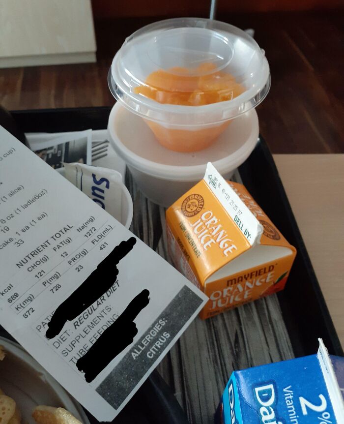 Hospital meal tray with orange juice and a nutrition label highlighting citrus allergies, showing selfish people making life harder.