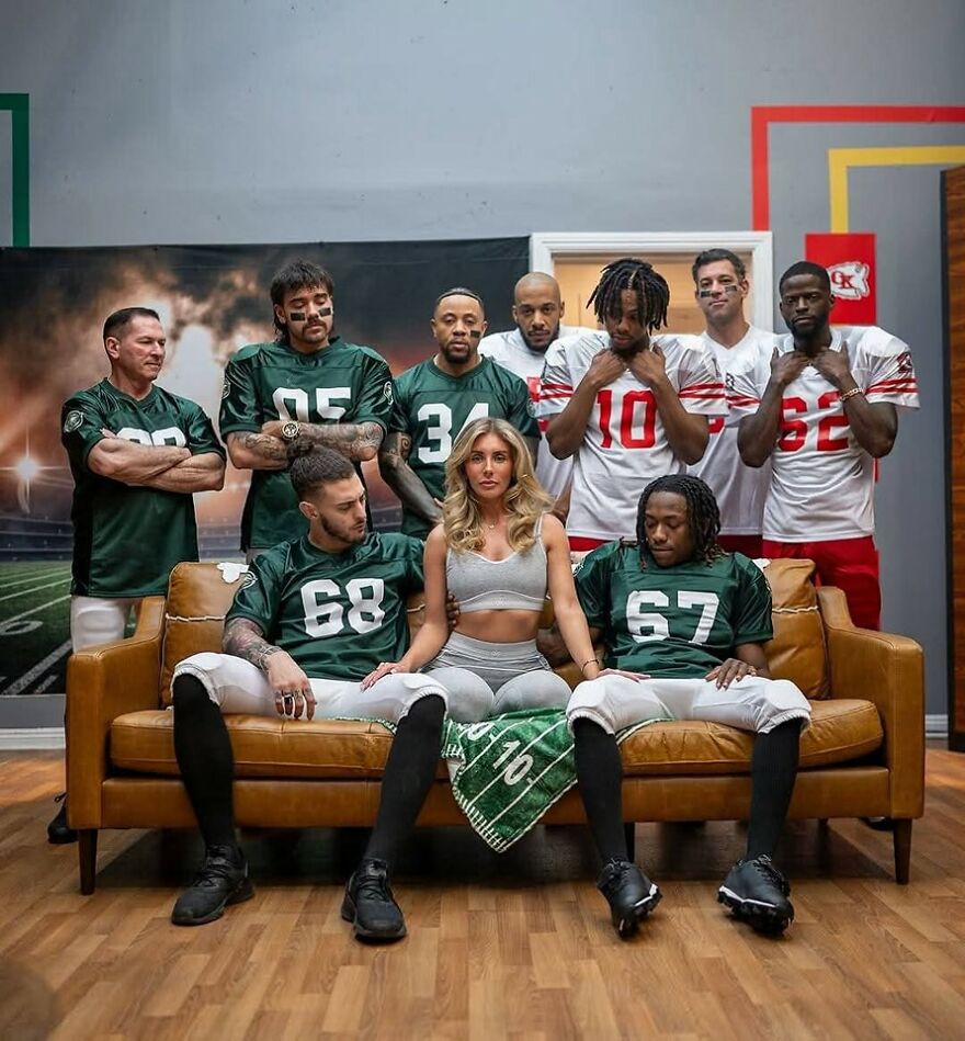 Bonnie Blue seated on a couch surrounded by football players in green and white jerseys during an indoor photoshoot. Bonnie Blue seated on a couch surrounded by football players in green and white jerseys during an indoor photoshoot.