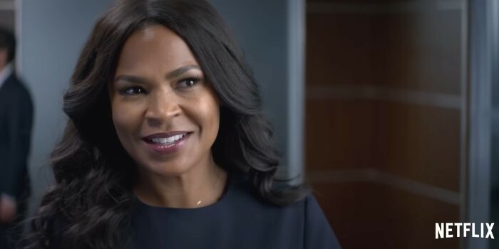 Woman with long dark hair smiling in a scene from one of the Netflix movies that turned out to be total letdowns.