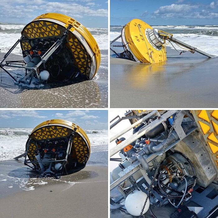 Yellow scientific buoy with mechanical parts washed ashore on a beach, an interesting and bizarre thing found at the beach.