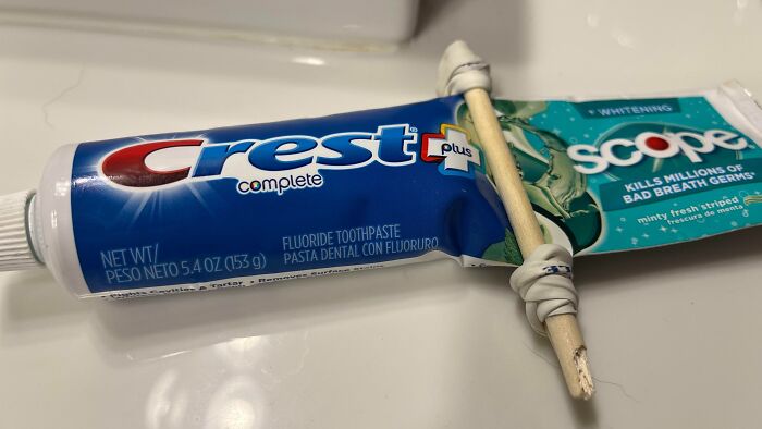 Toothpaste tube squeezed with a stick to save product featuring genius life hacks people actually use.