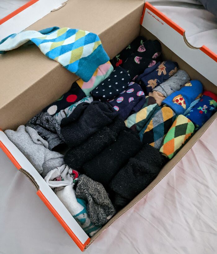 Socks neatly organized and stored in a shoebox showcasing a genius life hack for smart home organization.