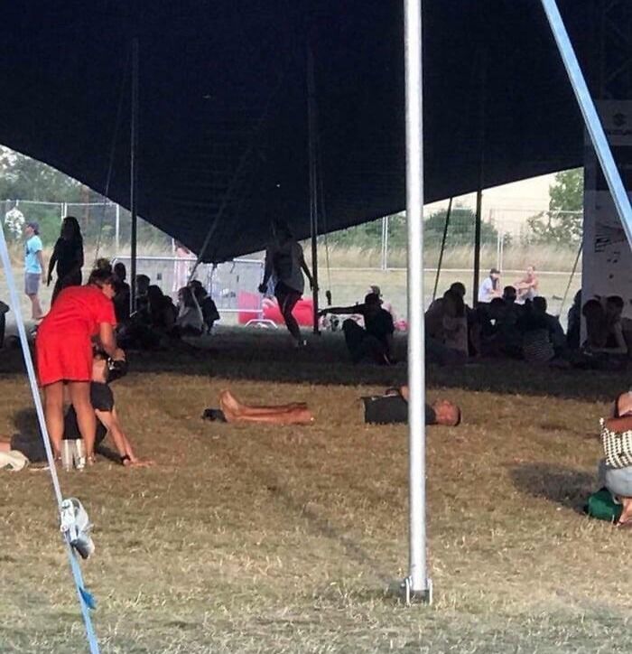 People lying on grass camouflaged by shadows under tent, showcasing things that matched their surroundings perfectly.