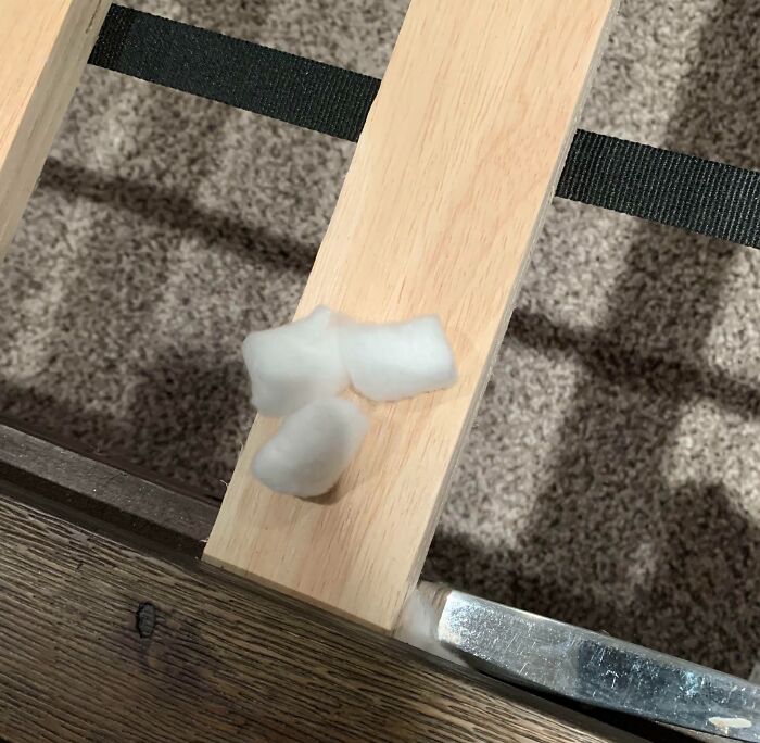 Bed frame showing cotton balls placed on screws to prevent noise, demonstrating genius life hacks that people actually use.