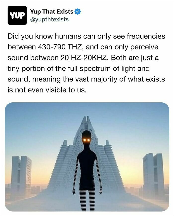 Surreal humanoid figure with glowing eyes stands in front of futuristic buildings in a weird things that exist scene.