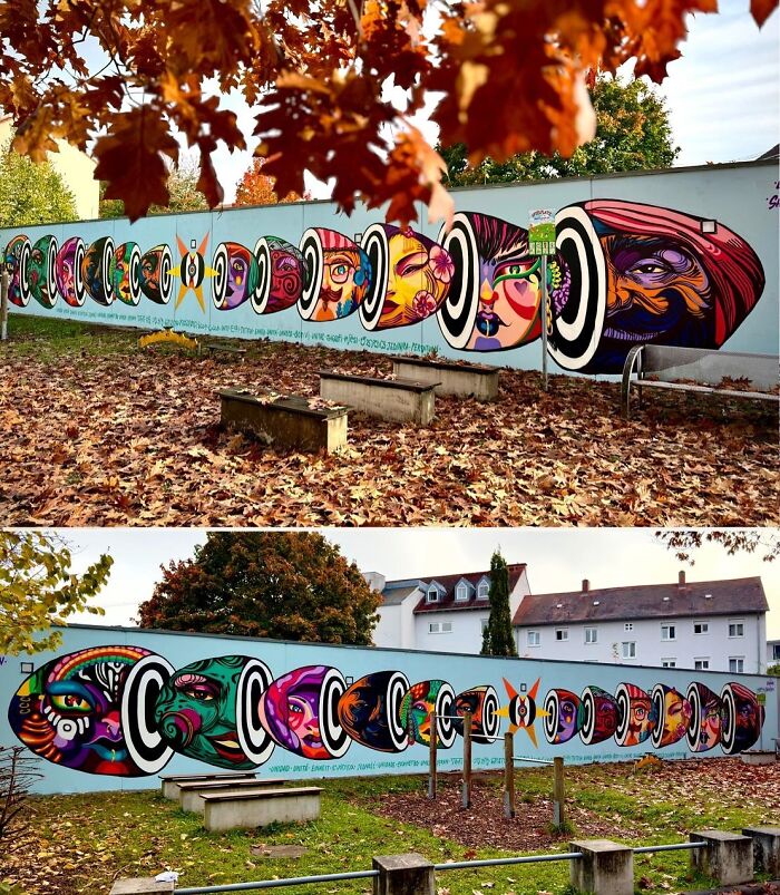 Colorful murals by Colombian artist SakoAsko blending fantasy and reality, displayed on an outdoor wall surrounded by autumn leaves.