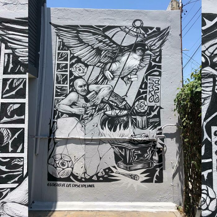 Black and white mural by Colombian artist SakoAsko featuring a man, a large bird in a cage, and surreal fantasy elements.