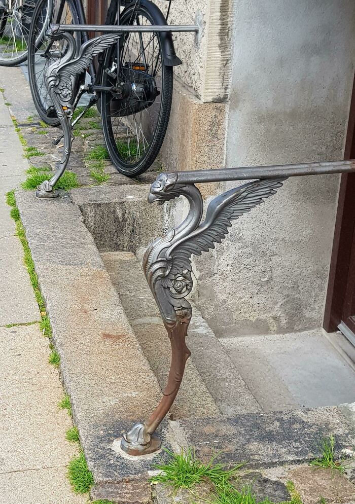 Ornate metal railing with winged designs outside a Danish prison cell entrance, showcasing unique Danish craftsmanship.