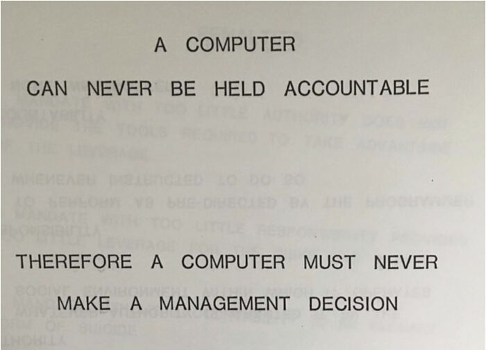Text on paper stating a computer can never be held accountable and must never make a management decision.