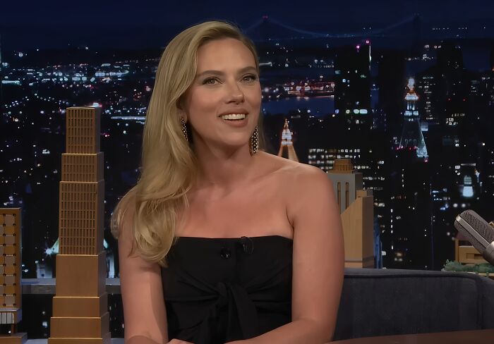 Actress on a late night talk show set, illustrating celebrities showing entitlement by talking about work and life.