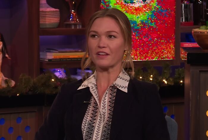 Woman in a patterned blouse and blazer speaking during a TV interview about celebrities and entitlement in work and life discussions